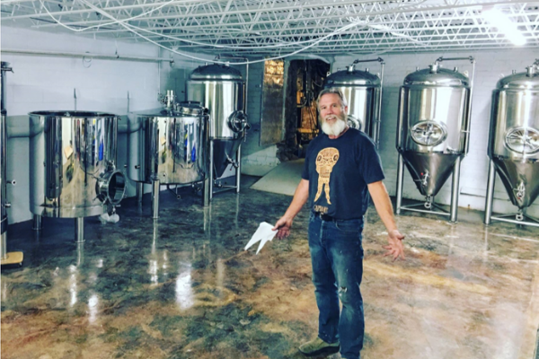 Man standing in tap room of brewery